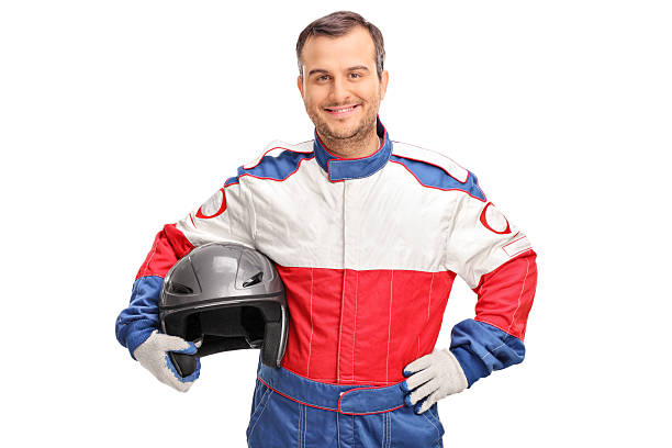 Young car racer holding a gray helmet Studio shot of a young car racer holding a gray helmet and looking at the camera isolated on white background race car driver stock pictures, royalty-free photos & images