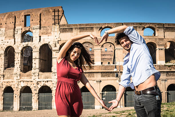 istock couple doing heart shape at rome 502390604