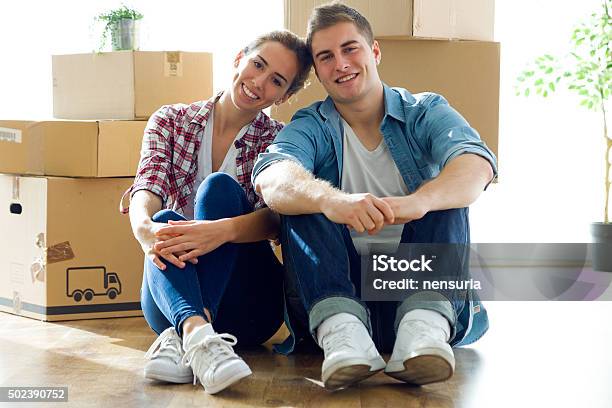 Pretty Young Couple Moving In New Home Stock Photo - Download Image Now - 2015, 30-39 Years, Adult