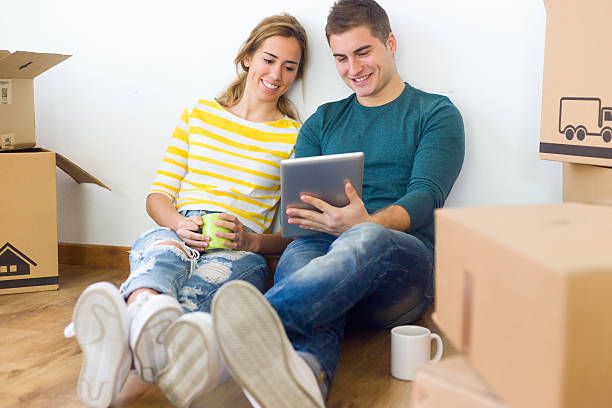 istock Young couple with digital tablet in their new home 502391440