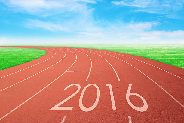 istock 2016 on red racing track with green grass and sky 502392578
