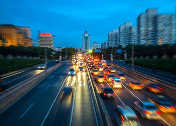 Long exposure of traffic in curve with red and white trails of light.