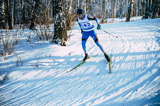 Chelyabinsk, Russia -  December 19, 2015: young skier athlete winter birch forest sprint race in classic style during Championship of Chelyabinsk in cross-country skiing