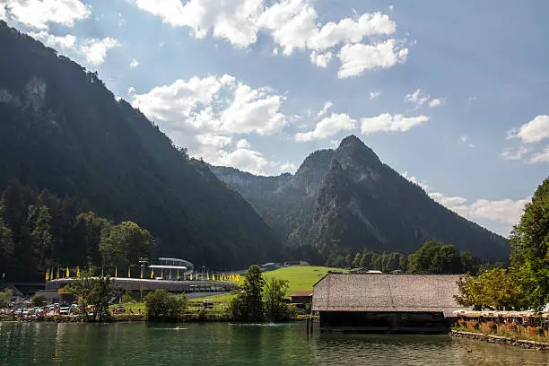 View on the Koenigssee lake on a sunny day with the bobsleigh run in the background