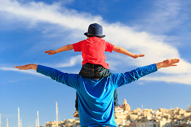 istock happy father and little son play on sky 502411226