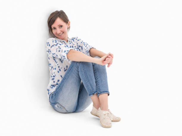 istock Beautiful woman sitting on white and smiling 502411336