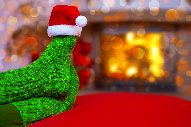 istock Feet in woollen blue socks and Santa hat . 502416102