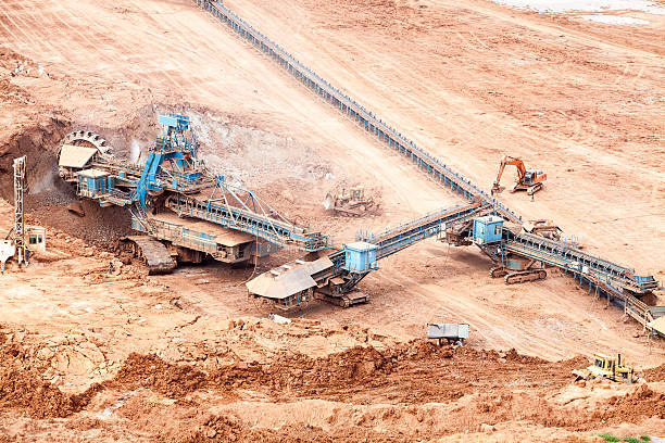 istock Part of a pit with big mining truck working 502417775