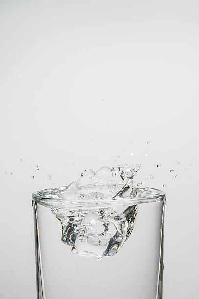 istock Drop Ice cubes into water, water splashing from glass 502418490