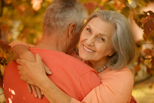 istock Old couple posing at autumn park 502418646