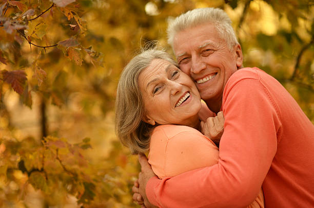 istock Old couple posing at autumn park 502419504