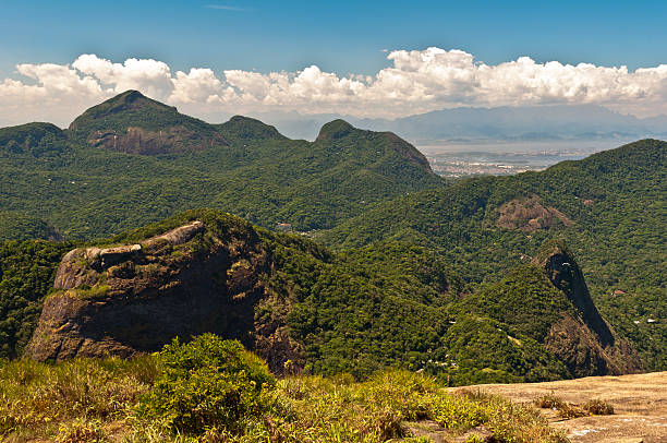 Man looking at Rio de Janeiro from above, shot from Pedra da Gavea.