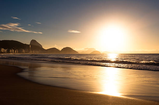 Sunrise in the Beach Sunrise in Famous Copacabana Beach in Rio de Janeiro, Brazil. copacabana stock pictures, royalty-free photos & images