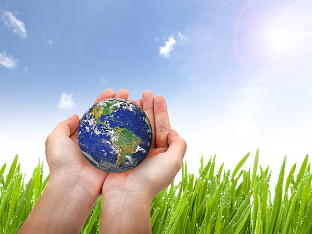 istock Earth planet in female hand and blue sky 502420258
