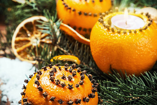 istock dried oranges with nuts and burning candles 502421560