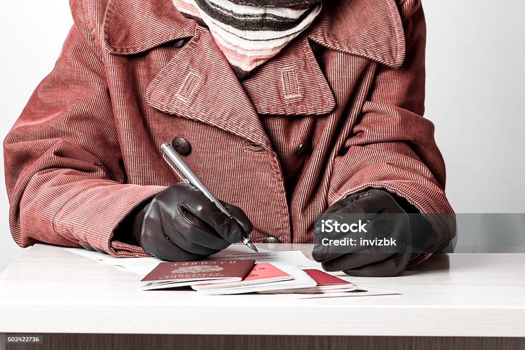 Woman fills the document forms at the table Female hands in gloves filling the document forms at the table.Female hands in gloves filling the document forms at the table. 2015 Stock Photo