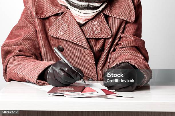 Woman Fills The Document Forms At The Table Stock Photo - Download Image Now - 2015, Adult, Application Form
