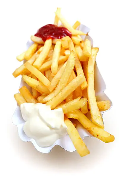 Macro shot with wide lens of French Fries, red, white, isolated on a white background