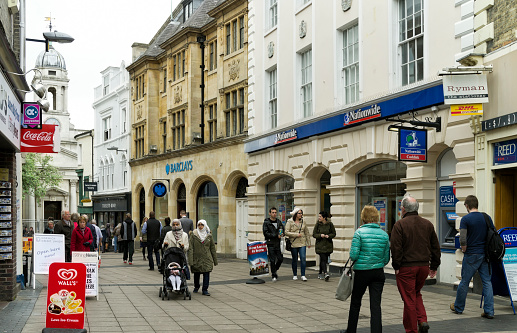 Norwich, Norfolk, England - May 13, 2014: People walking past branches of Barclays Bank and Nationwide Building Society in London Street, Norwich, in Eastern England. Barclays is an old established multinational banking group based in London while the Nationwide Building Society is a British financial institution based in Swindon and is the biggest building society in the world.