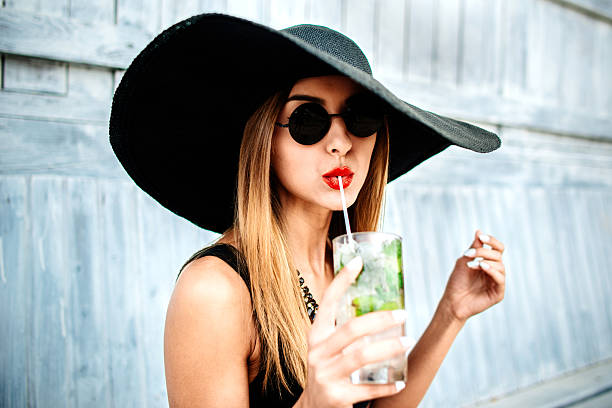 Pretty young girl drink cold coctail outdoor in beach cafe stock photo
