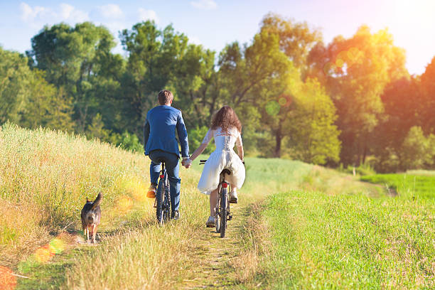 istock Bride and Groom ride bicycles 502423233