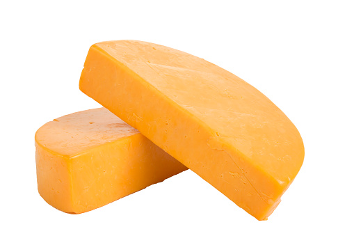 two half wheels of colby cheese on a white background