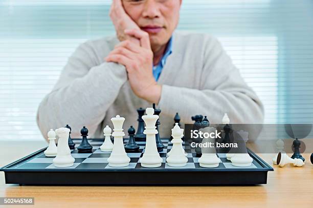 Senior Man Playing Chess Stock Photo - Download Image Now - 2015, 60-69 Years, Adult