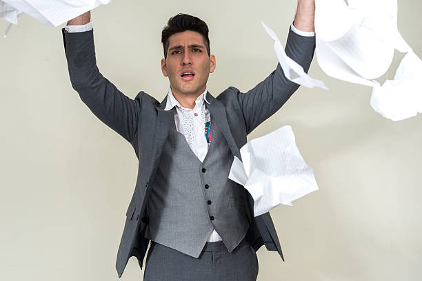 istock Portrait of businessman throwing paper documents 502446932