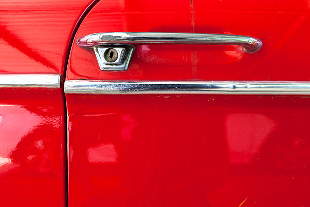 istock door handle of old bright red car surface texture background 502447439
