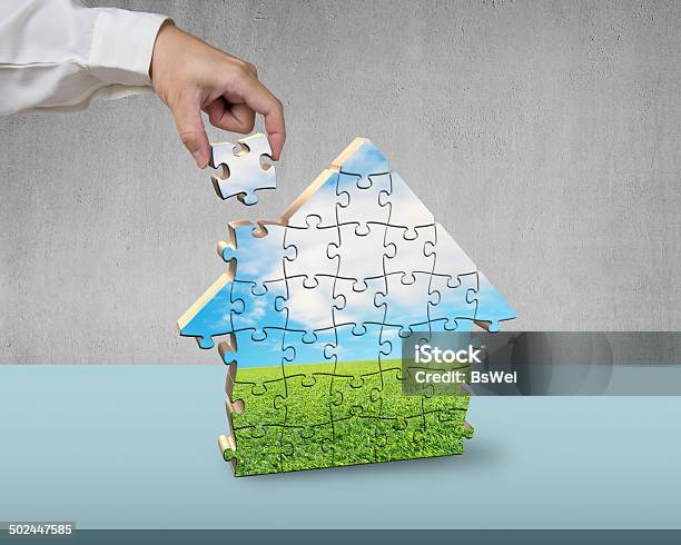 Assembling House Shape Puzzles Stock Photo - Download Image Now - Adult, Architecture, Building - Activity