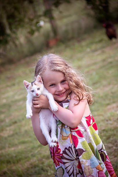 istock Happy child with cat. Kid showing 502447879