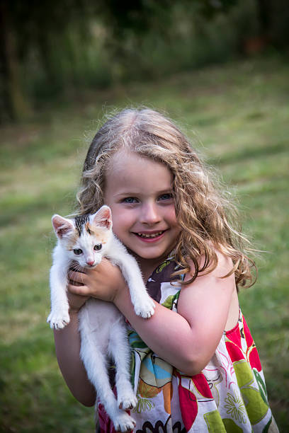 istock Happy child with cat. Kid showing 502448165