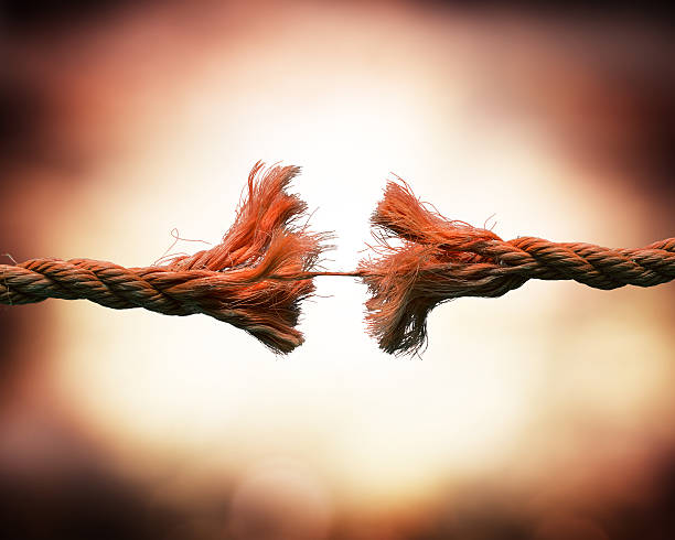 tension concept rope that is about to break, with eerie background Frayed stock pictures, royalty-free photos & images