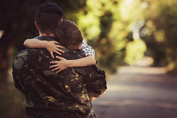 Little boy and soldier in a military uniform stock photo