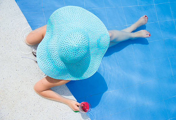 Beauty woman relaxing at the pool stock photo