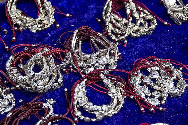 Various colorful handmade hanging ornaments made of threads and beads are beautifully displayed in the market, showcasing traditional craftsmanship and vibrant art from Pushkar, Rajasthan, India, during the Camel Fair.