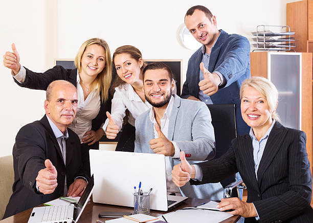 istock relaxed employees sitting at desk 502452062