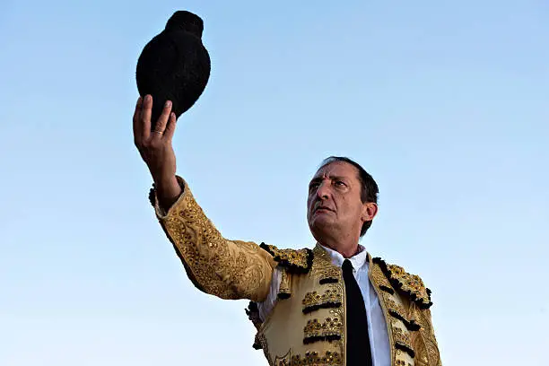 Bullfighter lifting the hat with blue sky in the background