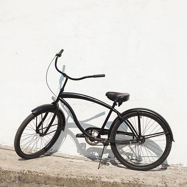 istock Black city bicycle cruiser standing by next white wall 502453369