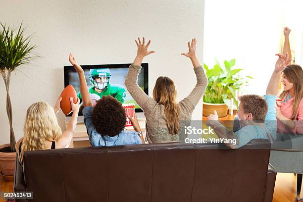 Group Of Friends Watching And Cheering Football Game Together Stockfoto en meer beelden van American football