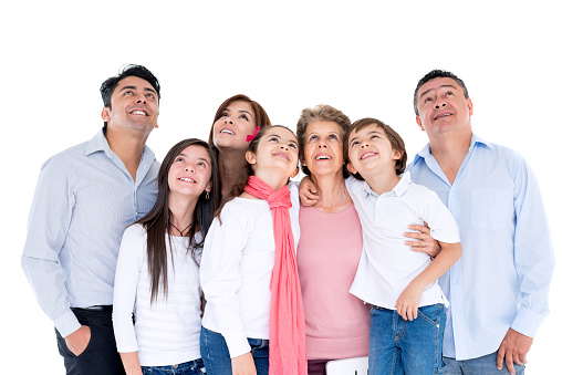 Thoughtful multi-generation family looking up in studio