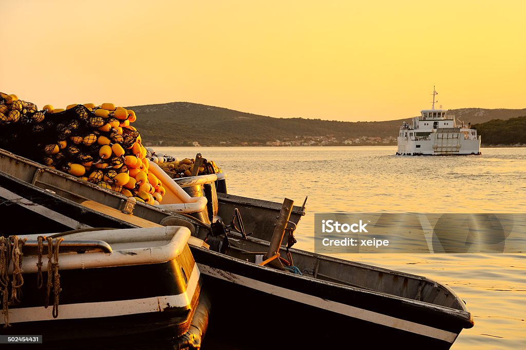 Fishing boat with fishing net in the harbor at sunset Adriatic Sea Stock Photo