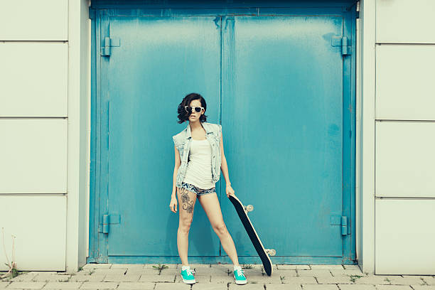 istock Young brunette woman posing with skateboard 502454913