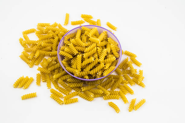 istock spiral raw macaroni pasta background 502459816