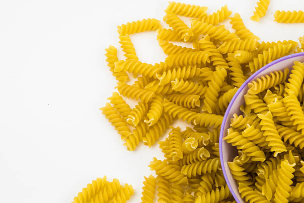 istock spiral raw macaroni pasta background 502459828