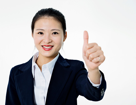 Beautiful asian businesswoman making thumbs up isolated on white background.