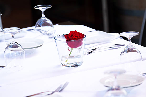 istock Prepared tables with glasses and rose 502473723