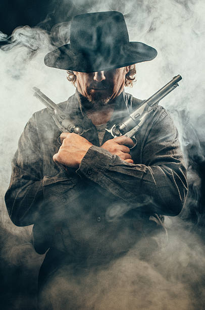 Gunslinger in the shadows stock photo