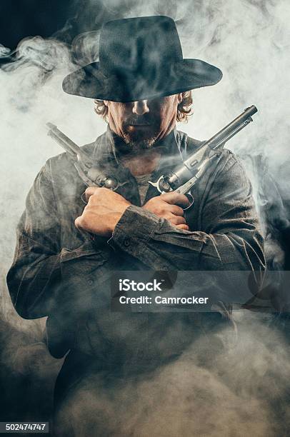 Gunslinger In The Shadows Stock Photo - Download Image Now - Cowboy, Gun, Wild West