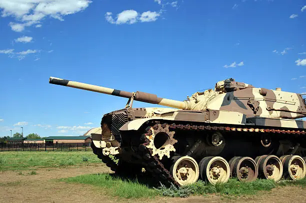 M60 Patton main battle tank with 105 mm M68 gun - M60A3 (camouflaged but unmarked, on static display outside Fort Carson Mountain Post, Colorado, USA)